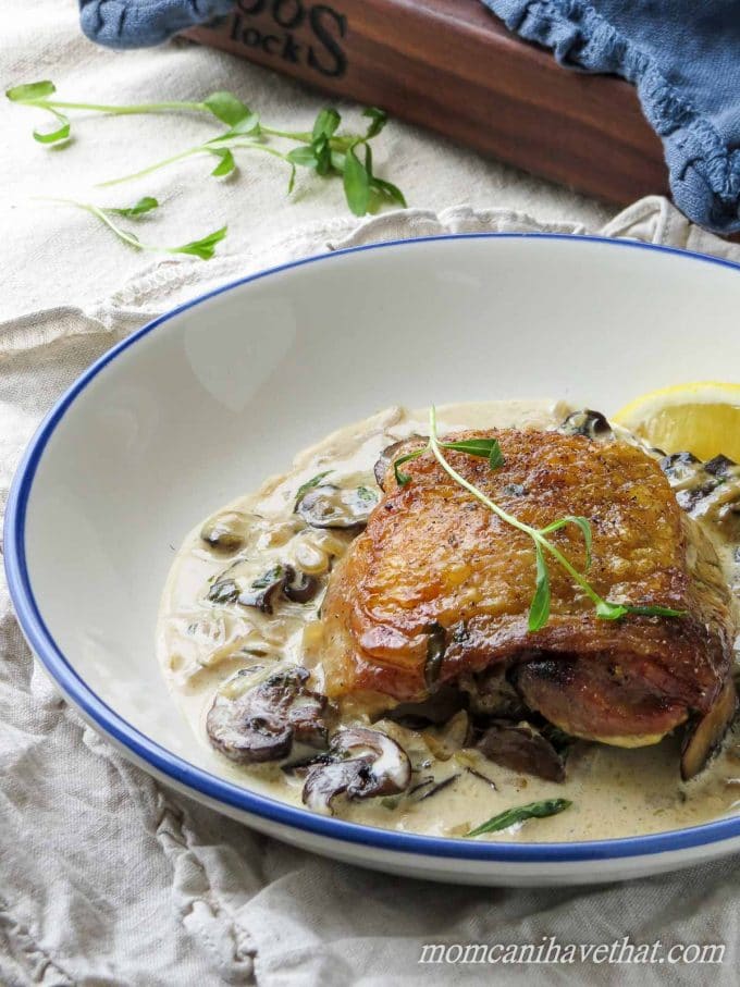 Chicken Thighs with Mushrooms and Tarragon Cream features golden chicken thighs in a white wine and cream sauce flavored with browned mushrooms and fresh tarragon. 7 net carbs per serving.