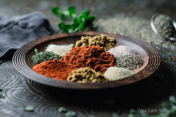 Homemade taco seasoning ingredients in a bowl with fresh oregano