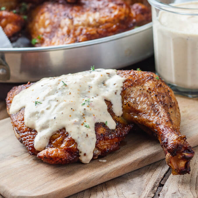 Alabama white BBQ sauce with smoked chicken quarters.