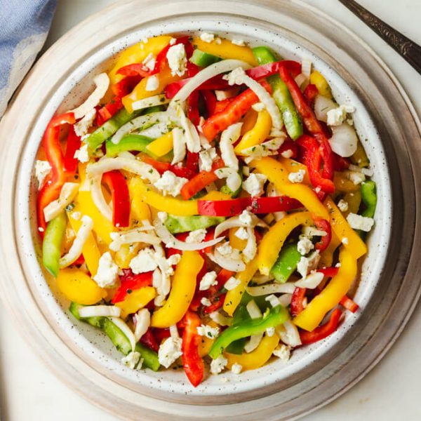 Colorful bell pepper salad with onions and feta.