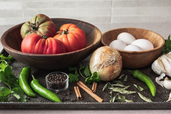 Egg masala (egg curry) ingredients: tomatoes, onion, garlic, green chilies, ginger, cinnamon, curry leaves.