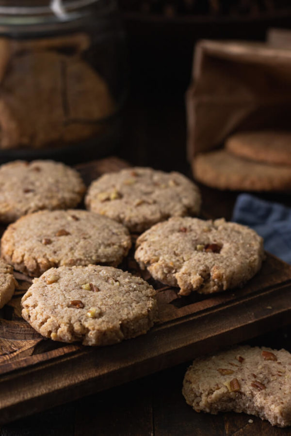 pecan sandies cookies on a trivet with more cookies in the background