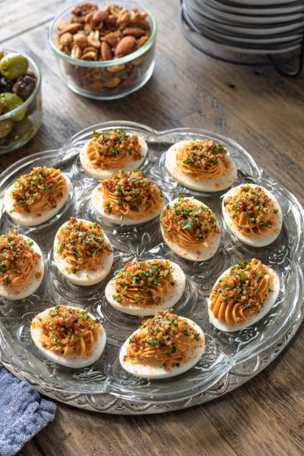 Keto deviled eggs with bacon and chipotle on vintage egg platter